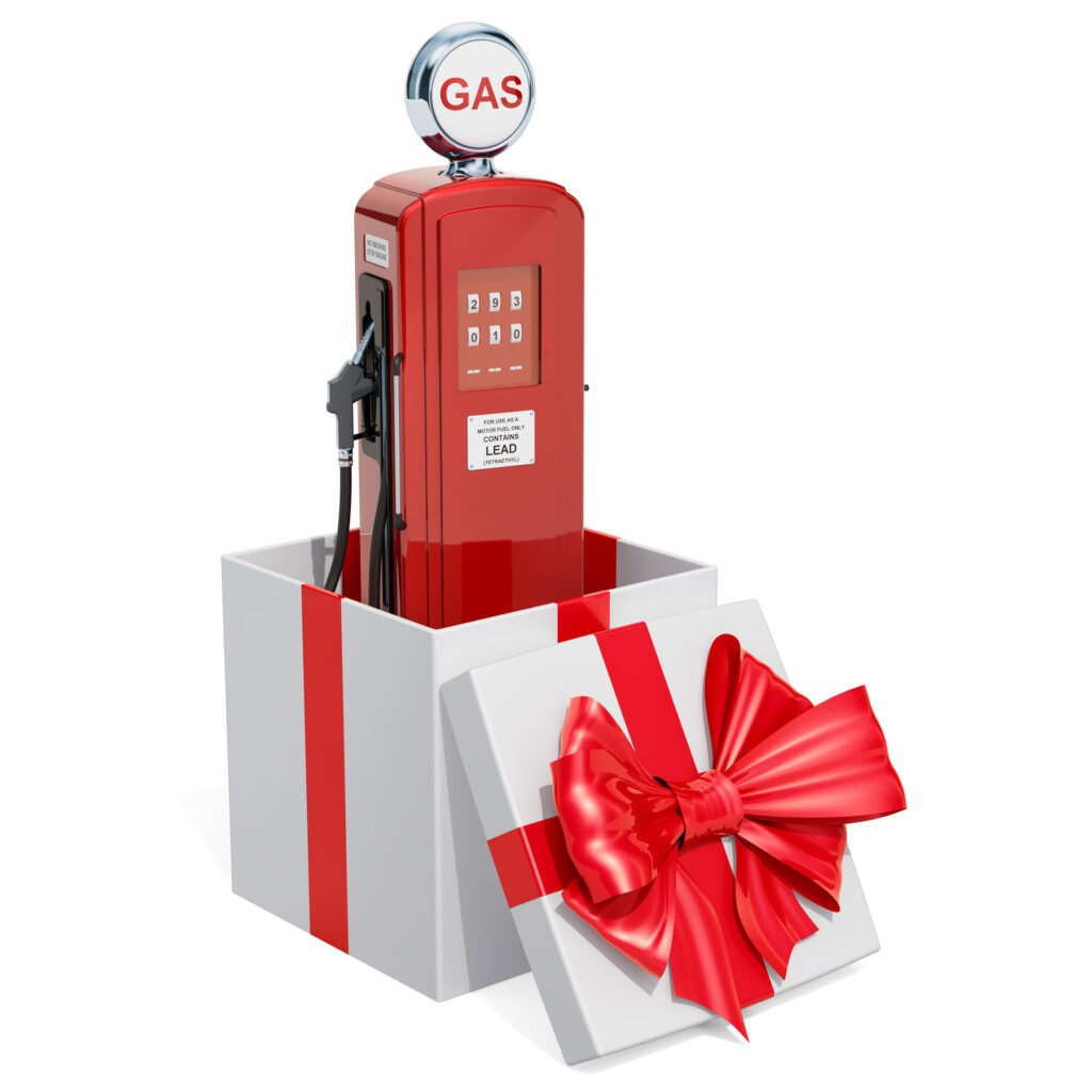Red vintage gas pump inside a gift box with a big red bow.