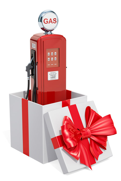 A red vintage gas pump inside a white gift box with a red ribbon.